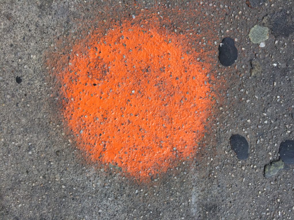 orange spot on sidewalk